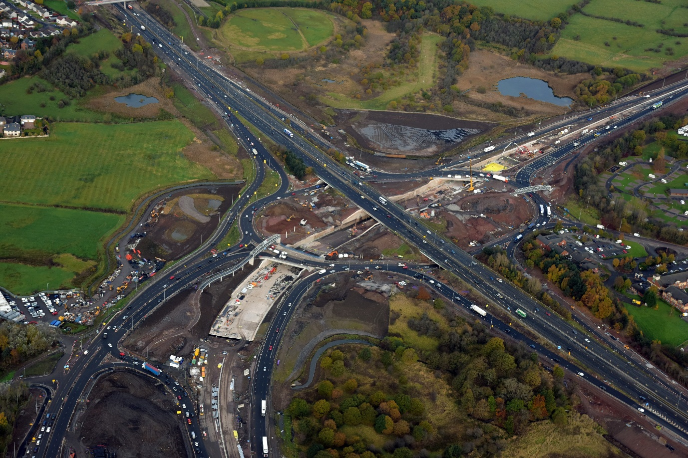 Aerial view of Raith Junction during construction circa Dec 2016, showing completion of piling and emergence of the A725 underpass below the M74