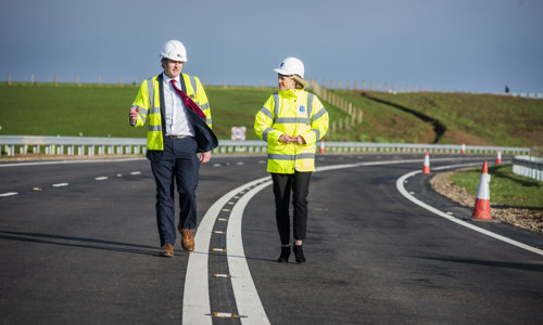 Transport Minister Jenny Gilruth walking with site staff at the new A77 Maybole Bypass