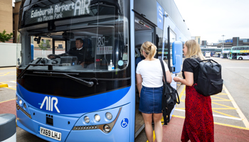 Two girls getting on a bus for free due to the Under 22's scheme.