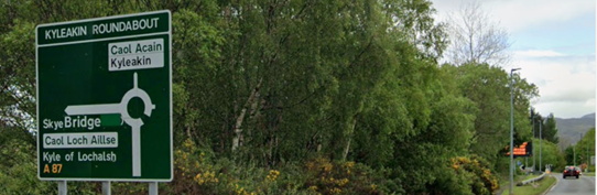 Green primary route direction sign on the southbound A87 at Kyleakin roundabout, including direction to Skye Bridge and Kyle of Lochalsh (with Gaelic version of Kyle of Lochalsh only, in white box)