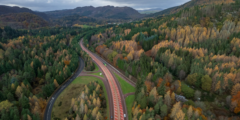 A9 carriageway looking north, surrounded by trees and beneth a cloudy sky